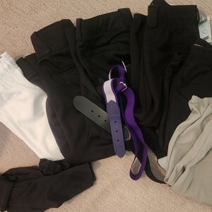 6 pairs of girls size small softball pants and two belts.